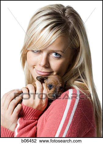 Woman holding a puppy View Large Photo Image Stock Image - Woman holding a puppy. Fotosearch