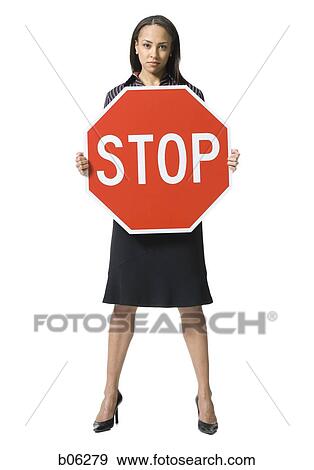 Stock Photo - Woman holding a stop sign. Fotosearch