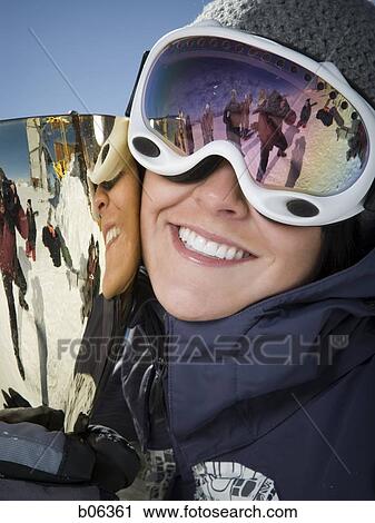 Stock Image - Woman holding a trophy. Fotosearch