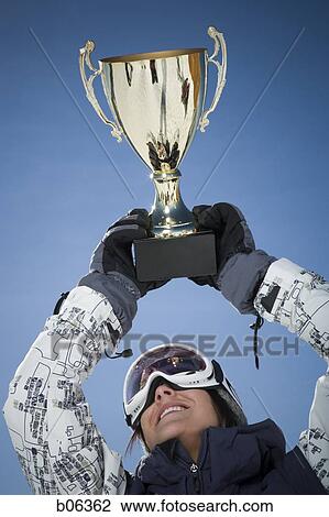 Stock Image - Woman holding a trophy. Fotosearch