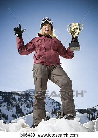 Woman holding a trophy View Large Photo Image Stock Photo - Woman holding a trophy. Fotosearch