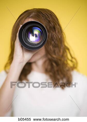 Woman holding camera lens View Large Photo Image Stock Photography - Woman holding camera lens. Fotosearch