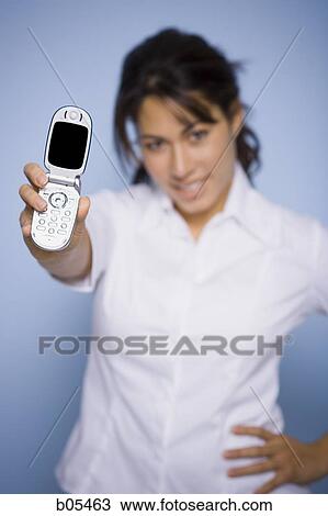 Woman holding cellular phone View Large Photo Image Stock Image - Woman holding cellular phone. Fotosearch