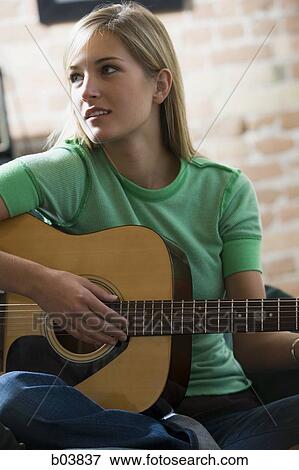 Woman holding guitar View Large Photo Image Stock Photo - Woman holding guitar. Fotosearch