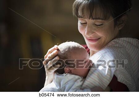 Picture - Woman holding newborn. Fotosearch