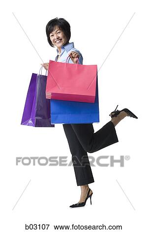 Woman holding shopping bags View Large Photo Image Stock Photo - Woman holding shopping bags. Fotosearch