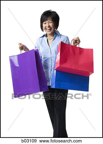 Woman holding shopping bags View Large Photo Image Stock Photo - Woman holding shopping bags. Fotosearch