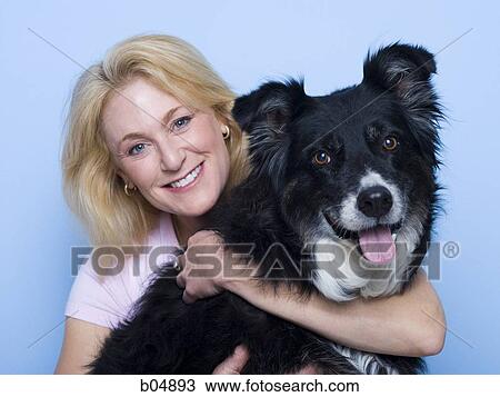 Woman hugging black dog View Large Photo Image Stock Image - Woman hugging black dog. Fotosearch