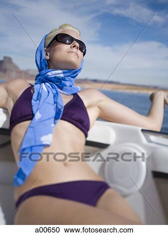 Woman in bikini on boat with headscarf and sunglasses View Large Photo Image Stock Image - Woman in bikini on boat with headscarf and sunglasses. Fotosearch