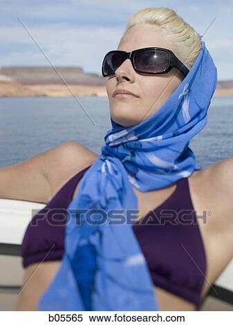 Woman in bikini on boat with headscarf and sunglasses View Large Photo Image Stock Photography - Woman in bikini on boat with headscarf and sunglasses. Fotosearch