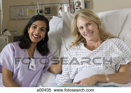 Stock Photography - Woman in hospital bed smiling. Fotosearch