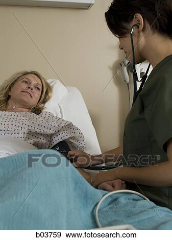Stock Photo - Woman in hospital bed. Fotosearch