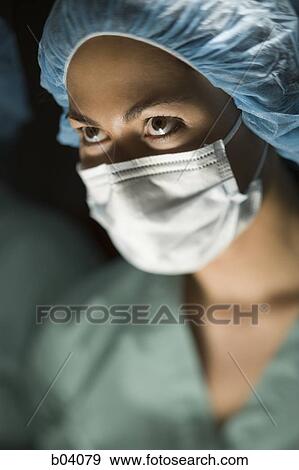 Woman in surgical scrubs looking up View Large Photo Image Stock Photo - Woman in surgical scrubs looking up. Fotosearch