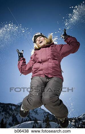 Woman jumping outside in the snow View Large Photo Image Stock Photo - Woman jumping outside in the snow. Fotosearch