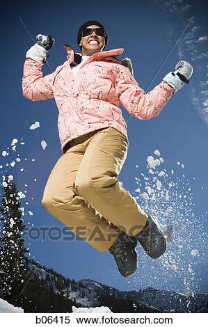 Woman jumping outside in the snow View Large Photo Image Stock Photography - Woman jumping outside in the snow. Fotosearch
