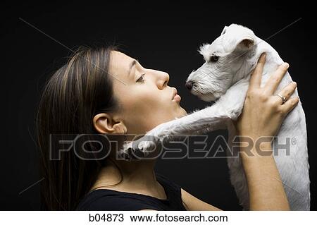 Woman kissing white dog View Large Photo Image Stock Image - Woman kissing white dog. Fotosearch