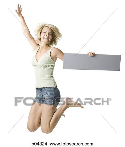 Picture - Woman leaping with blank sign. Fotosearch