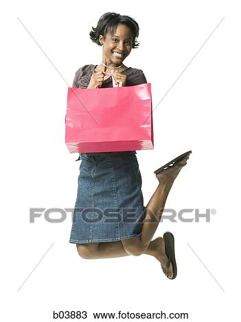 Woman leaping with gift bag View Large Photo Image Stock Image - Woman leaping with gift bag. Fotosearch