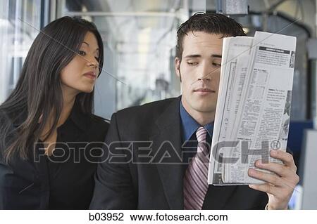 Woman looking over man's shoulder on bus or subway View Large Photo Image Stock Image - Woman looking over man's shoulder on bus or subway. Fotosearch