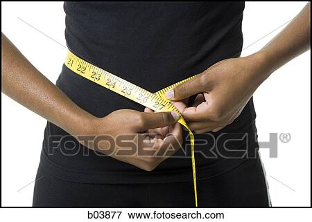 Woman measuring waist with tape measure View Large Photo Image Stock Photo - Woman measuring waist with tape measure. Fotosearch