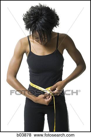 Woman measuring waist with tape measure View Large Photo Image Stock Photo - Woman measuring waist with tape measure. Fotosearch