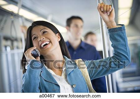 Woman on a cell phone in a subway View Large Photo Image Stock Photo - Woman on a cell phone in a subway. Fotosearch