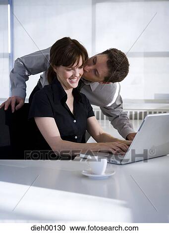 Woman on a laptop getting a kiss View Large Photo Image Stock Image - Woman on a laptop getting a kiss. Fotosearch