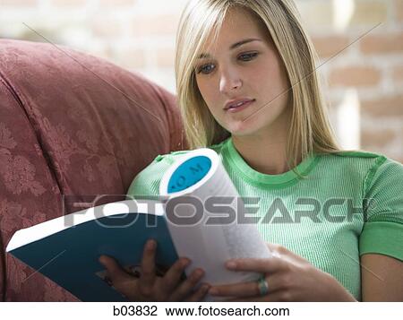 Woman on sofa reading View Large Photo Image Stock Image - Woman on sofa reading. Fotosearch