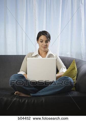 Woman on sofa with laptop View Large Photo Image Stock Image - Woman on sofa with laptop. Fotosearch