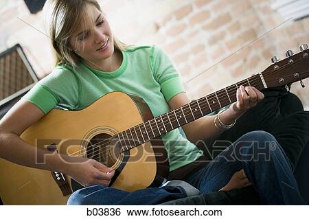 Woman playing guitar View Large Photo Image Stock Photograph - Woman playing guitar. Fotosearch