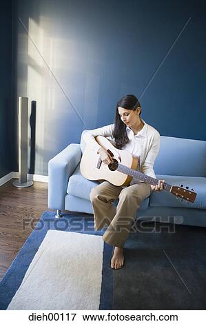 Stock Photo - Woman playing the guitar. Fotosearch