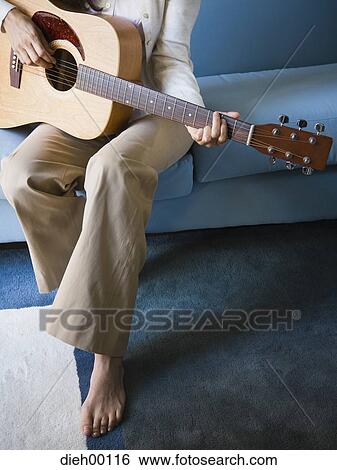 Woman playing the guitar View Large Photo Image Stock Photograph - Woman playing the guitar. Fotosearch