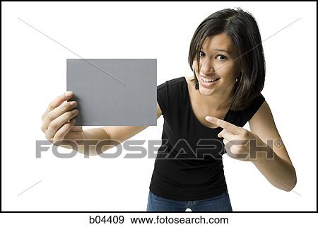 Stock Photo - Woman pointing at blank sign. Fotosearch
