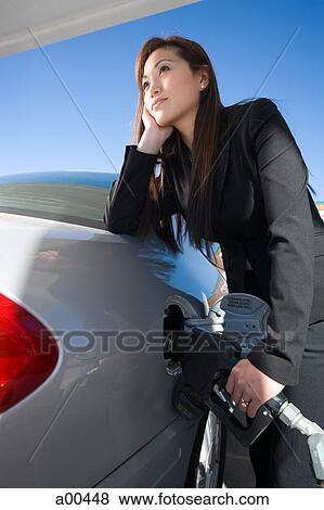 Woman pumping gas View Large Photo Image Stock Photo - Woman pumping gas. Fotosearch