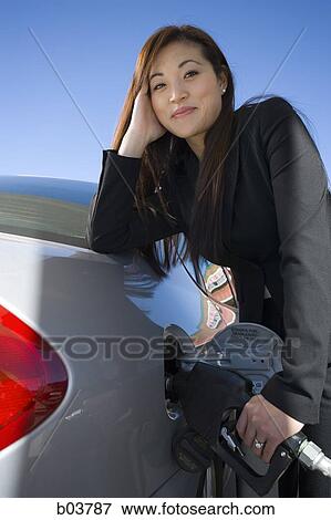 Woman pumping gas View Large Photo Image Stock Photo - Woman pumping gas. Fotosearch