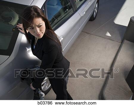 Woman pumping gas View Large Photo Image Stock Photograph - Woman pumping gas. Fotosearch