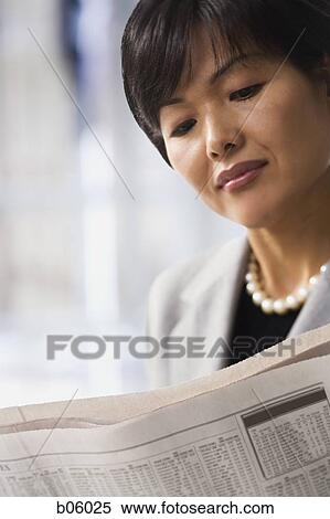 Woman reading the paper View Large Photo Image Stock Photography - Woman reading the paper. Fotosearch