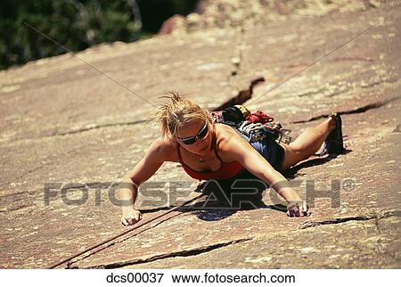 Stock Photo - Woman rock climbing. Fotosearch