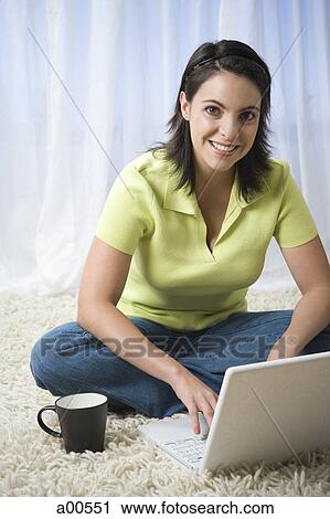 Woman sitting cross legged with laptop View Large Photo Image Stock Image - Woman sitting cross legged with laptop. Fotosearch