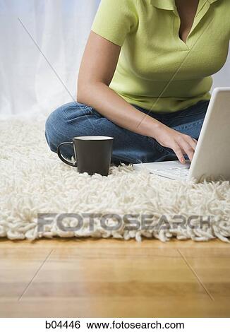 Woman sitting cross legged with laptop View Large Photo Image Stock Photograph - Woman sitting cross legged with laptop. Fotosearch