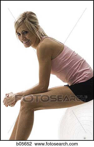 Woman sitting on a pilates ball View Large Photo Image Stock Image - Woman sitting on a pilates ball. Fotosearch