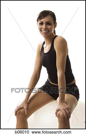 Woman sitting on a pilates ball View Large Photo Image Stock Image - Woman sitting on a pilates ball. Fotosearch