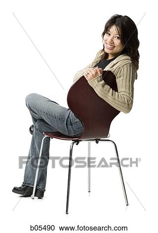 Woman sitting on chair smiling View Large Photo Image Stock Image - Woman sitting on chair smiling. Fotosearch
