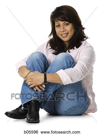 Woman sitting with arms around legs View Large Photo Image Stock Photograph - Woman sitting with arms around legs. Fotosearch