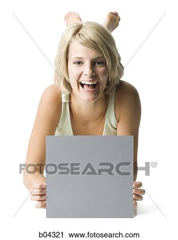 Stock Image - Woman sitting with blank sign. Fotosearch