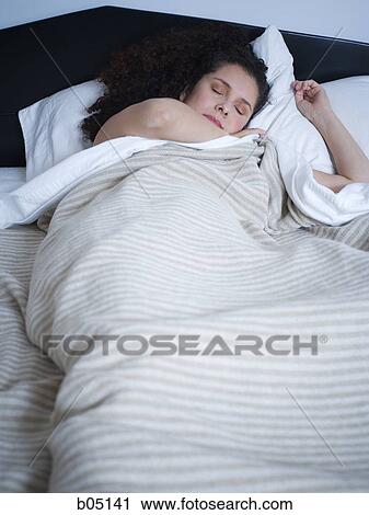 Stock Image - Woman sleeping in bed. Fotosearch