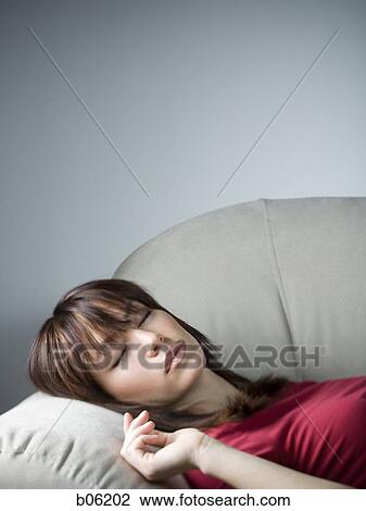 Woman sleeping on the couch View Large Photo Image Stock Image - Woman sleeping on the couch. Fotosearch