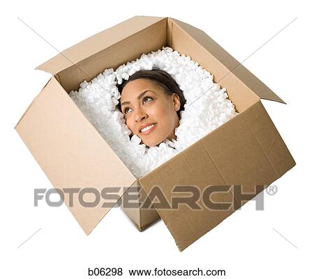 Stock Photo - Woman smiling in a cardboard box. Fotosearch