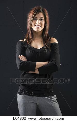 Woman standing with arms crossed smiling View Large Photo Image Stock Image - Woman standing with arms crossed smiling. Fotosearch
