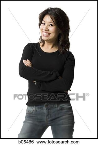 Woman standing with arms crossed smiling View Large Photo Image Stock Photograph - Woman standing with arms crossed smiling. Fotosearch